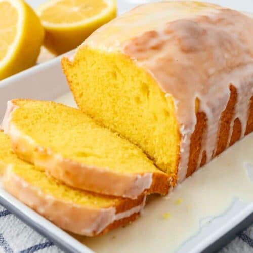 lemon loaf cake from a mix, served on a white platter and sliced.