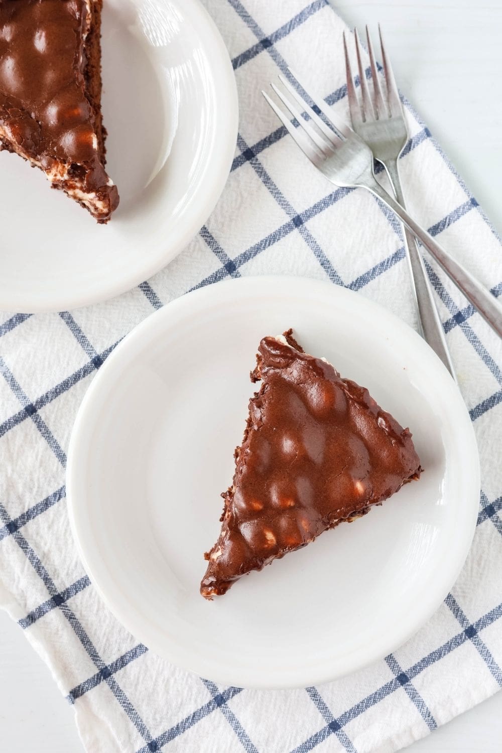 overhead view of two slices of Appalachian brownie pie, each served on a white plate, with forks next to the plates.