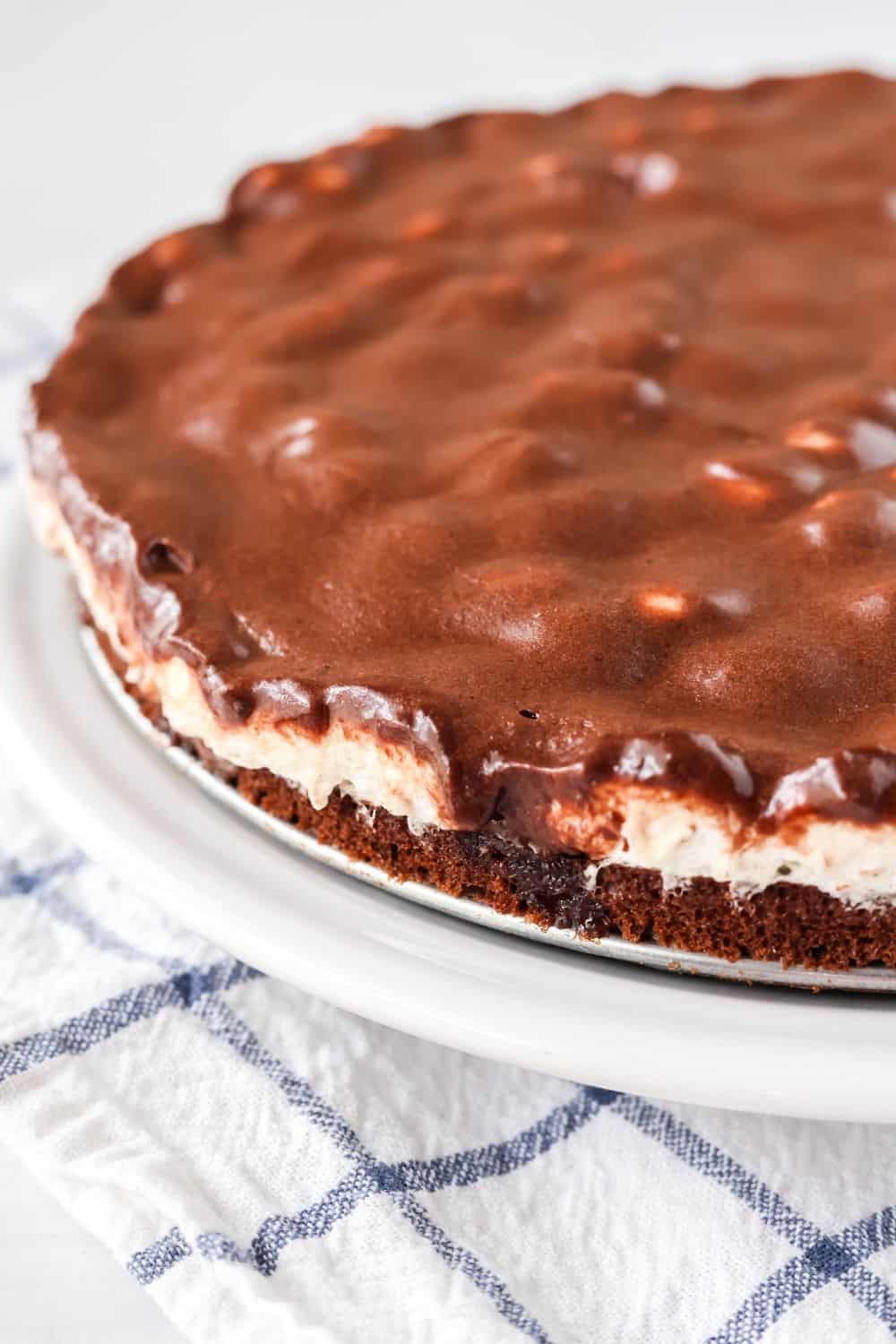 view of the side of a fudge brownie pie, including the brownie, marshmallow, and frosting layers.