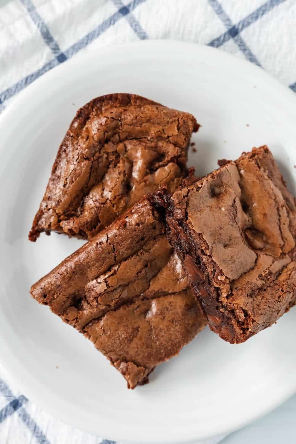 overhead view of three brownies made with Bisquick, served on a white plate
