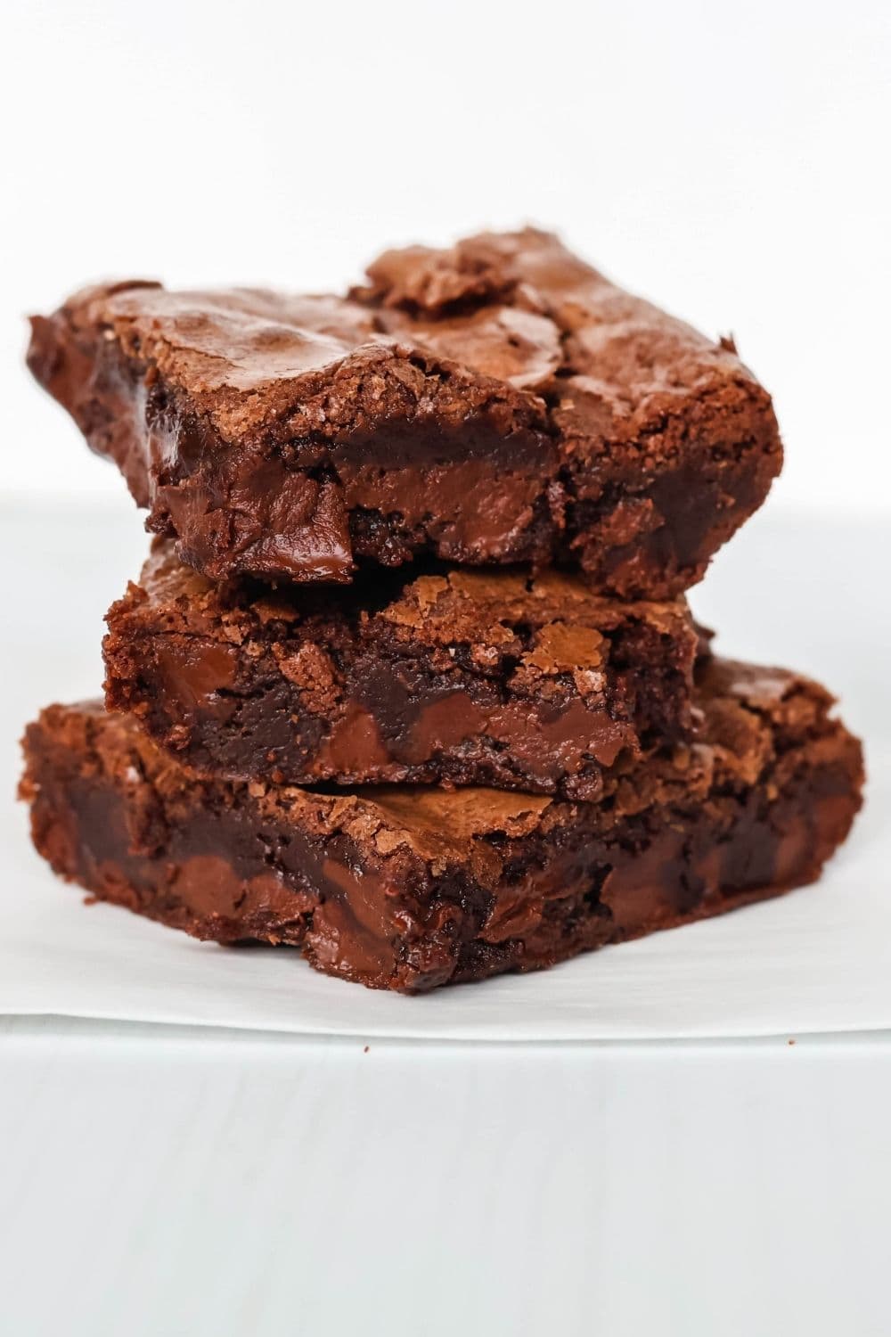 detailed side view of three squares of fudgy Bisquick brownies stacked on top of each other