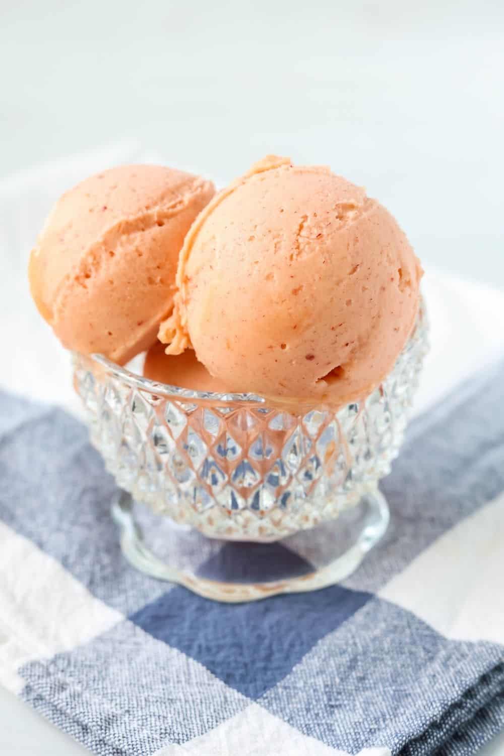 close-up side view of Ninja Creami peach sorbet served in a glass dish