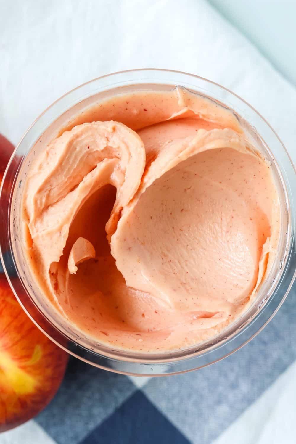 close-up overhead view of a Ninja Creami pint container of no-peel peach sorbet made with fresh peaches