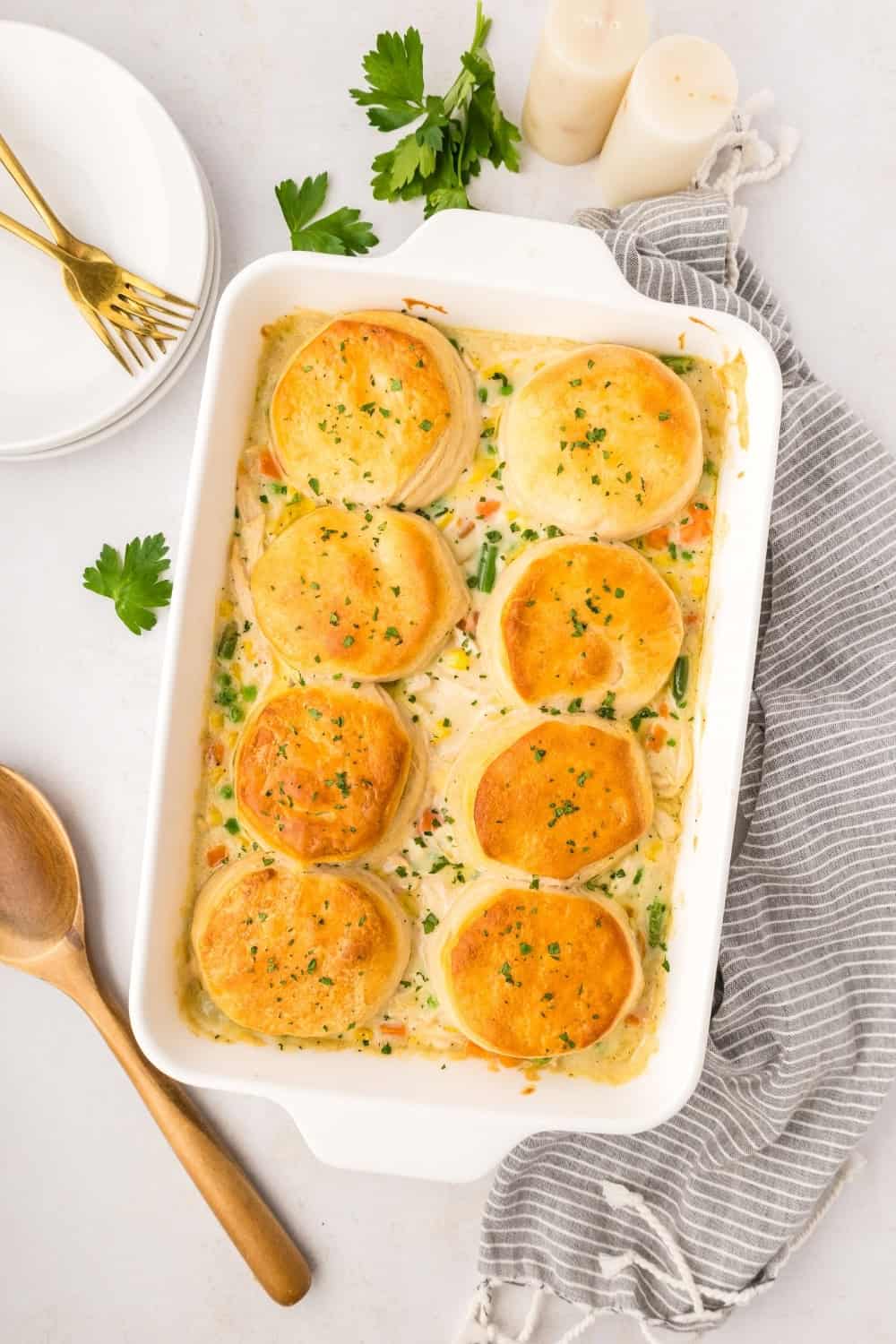 overhead view of a white baking dish filled with homemade biscuit chicken pot pie fresh out of the oven.