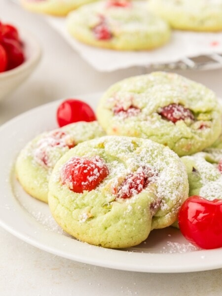 pistachio pudding cookies with cherries served on a white plate