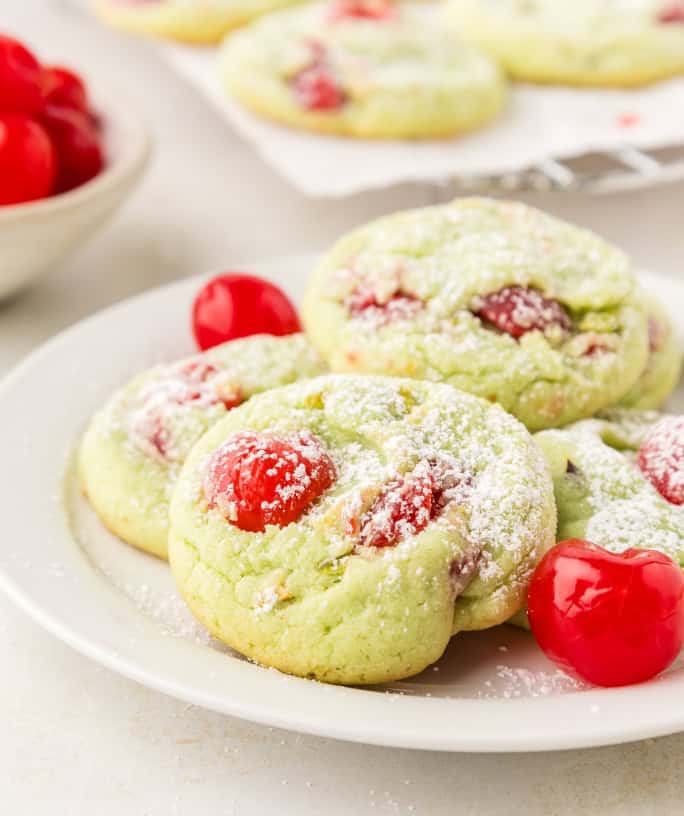 pistachio pudding cookies with cherries served on a white plate