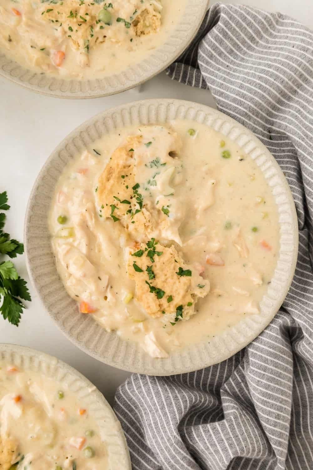 overhead view of three bowls filled with Crock Pot chicken and dumplings made with Bisquick.