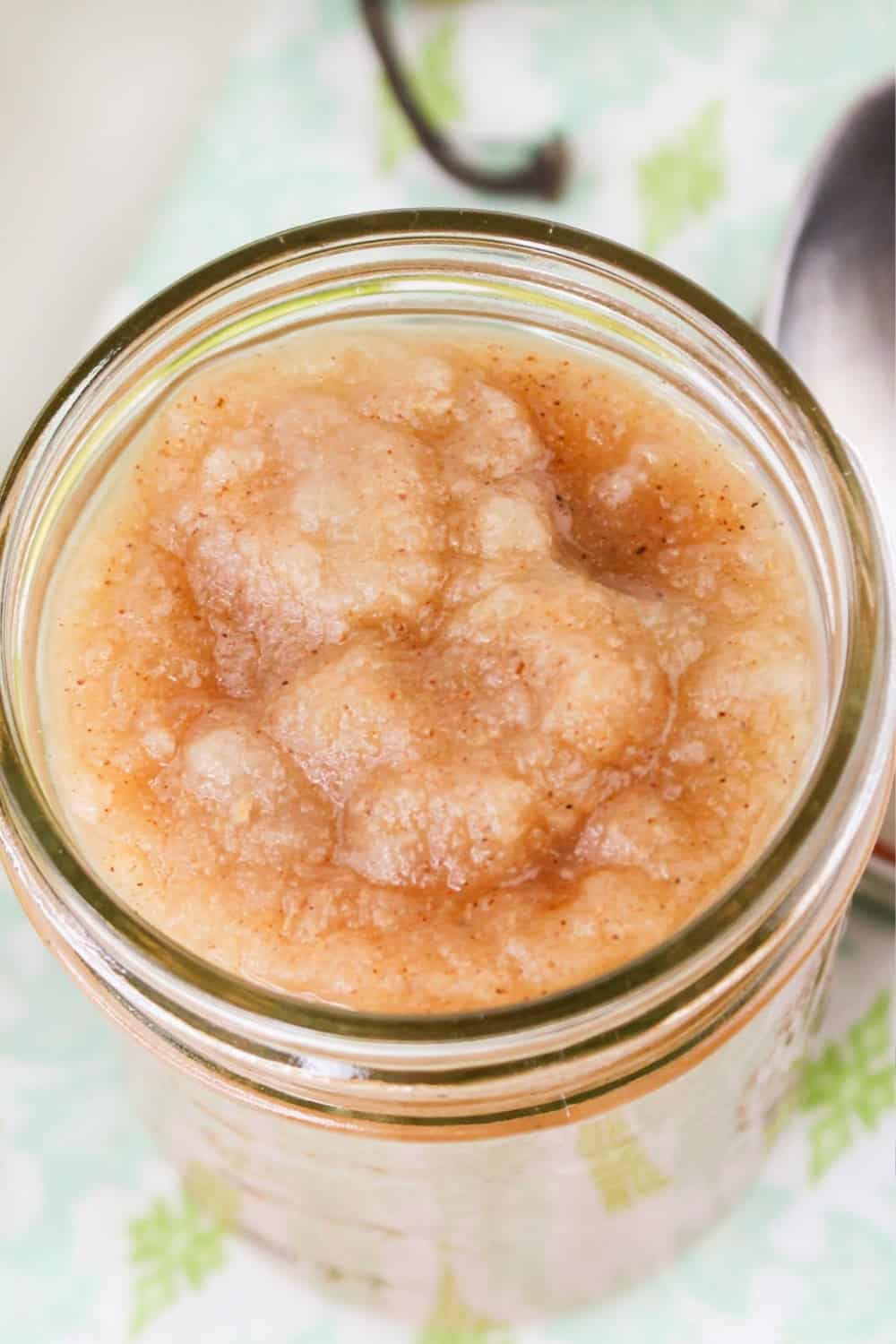 overhead view of a jar of cinnamon apple pear sauce.