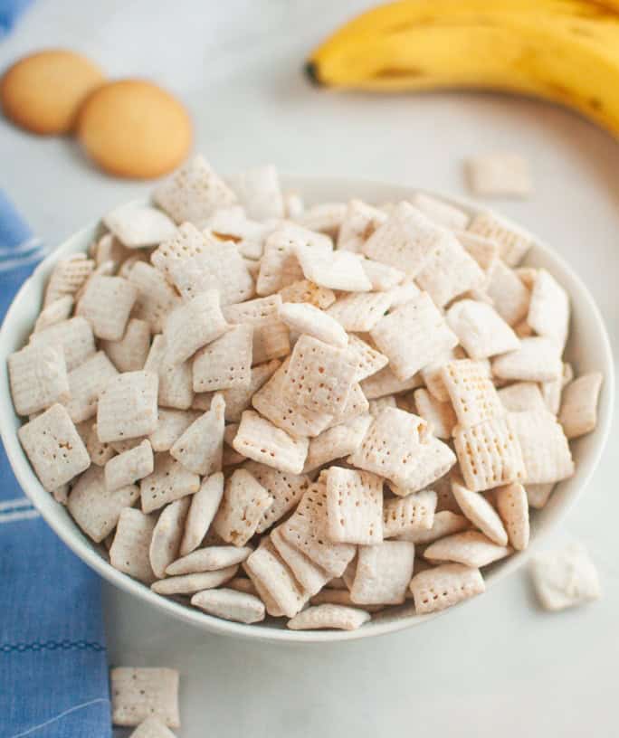 banana pudding Muddy Buddies snack mix served in a white bowl.