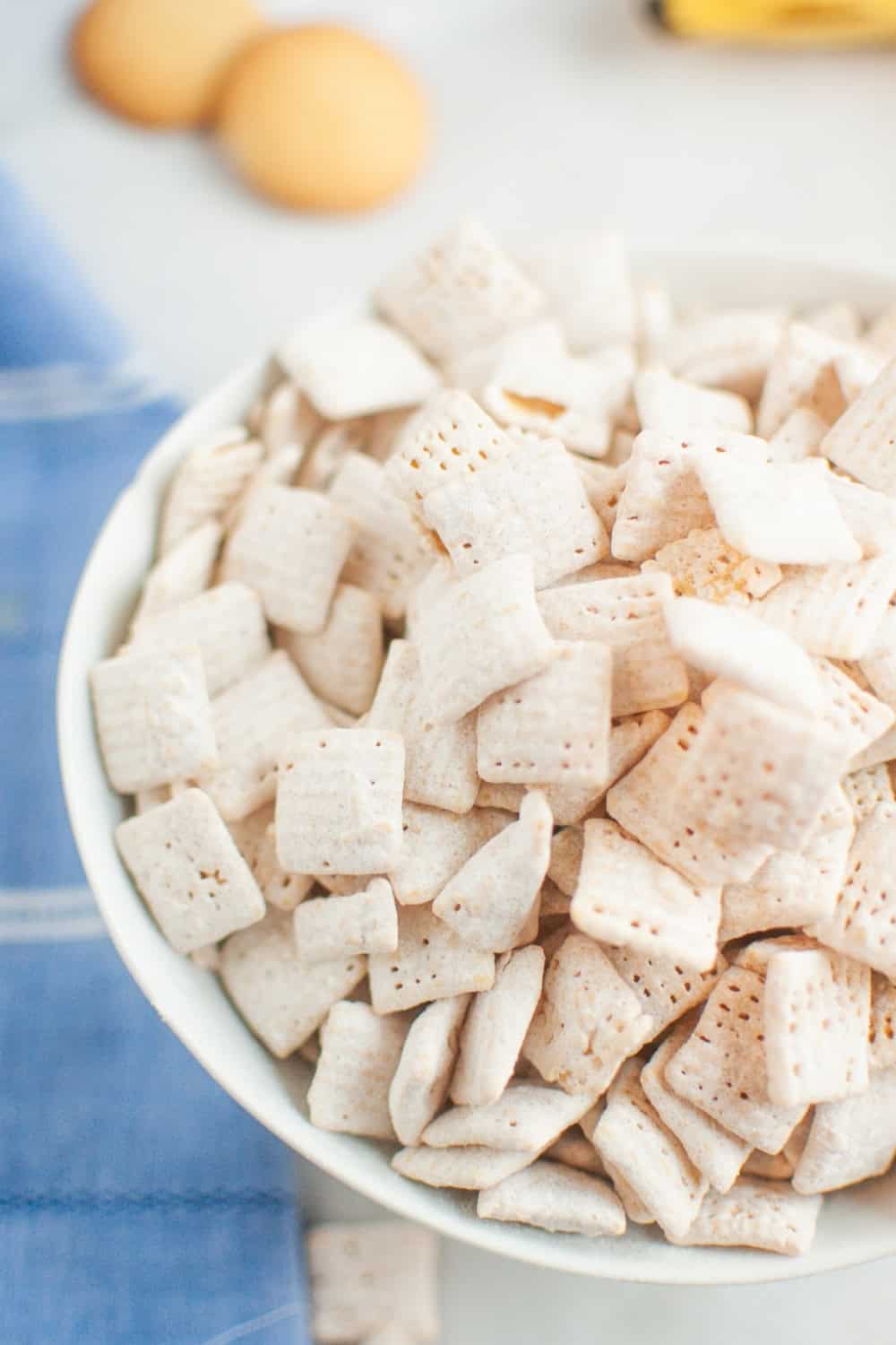 close-up view of banana-flavored Chex mix snack mix in a white bowl.