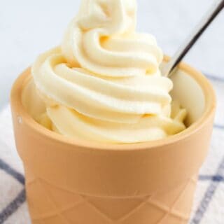 Ninja Creami Swirl vanilla soft serve ice cream in a dessert cup with a spoon.