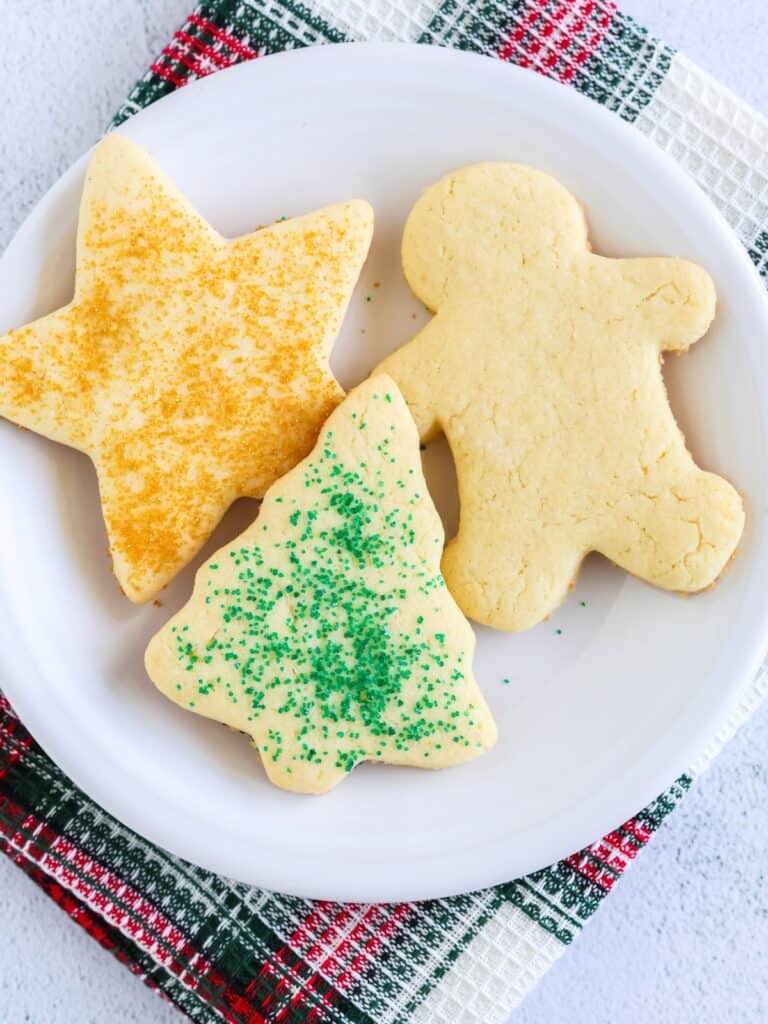 Three cake mix holiday cookies served on a white plate.