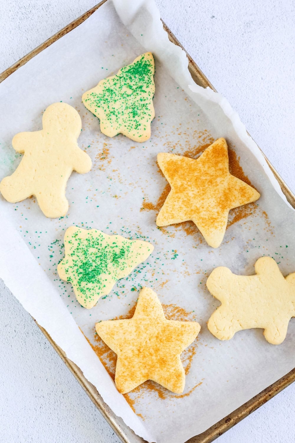 a cookie sheet with freshly baked Christmas cookies on it that were made using a box of cake mix.