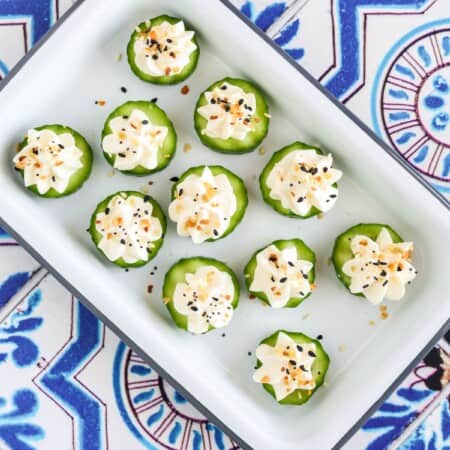 everything bagel cucumber bites served on an appetizer platter.