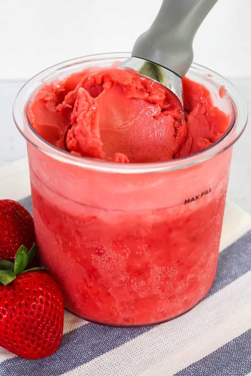 pint of healthy Ninja Creami strawberry sorbet made with fresh strawberries.