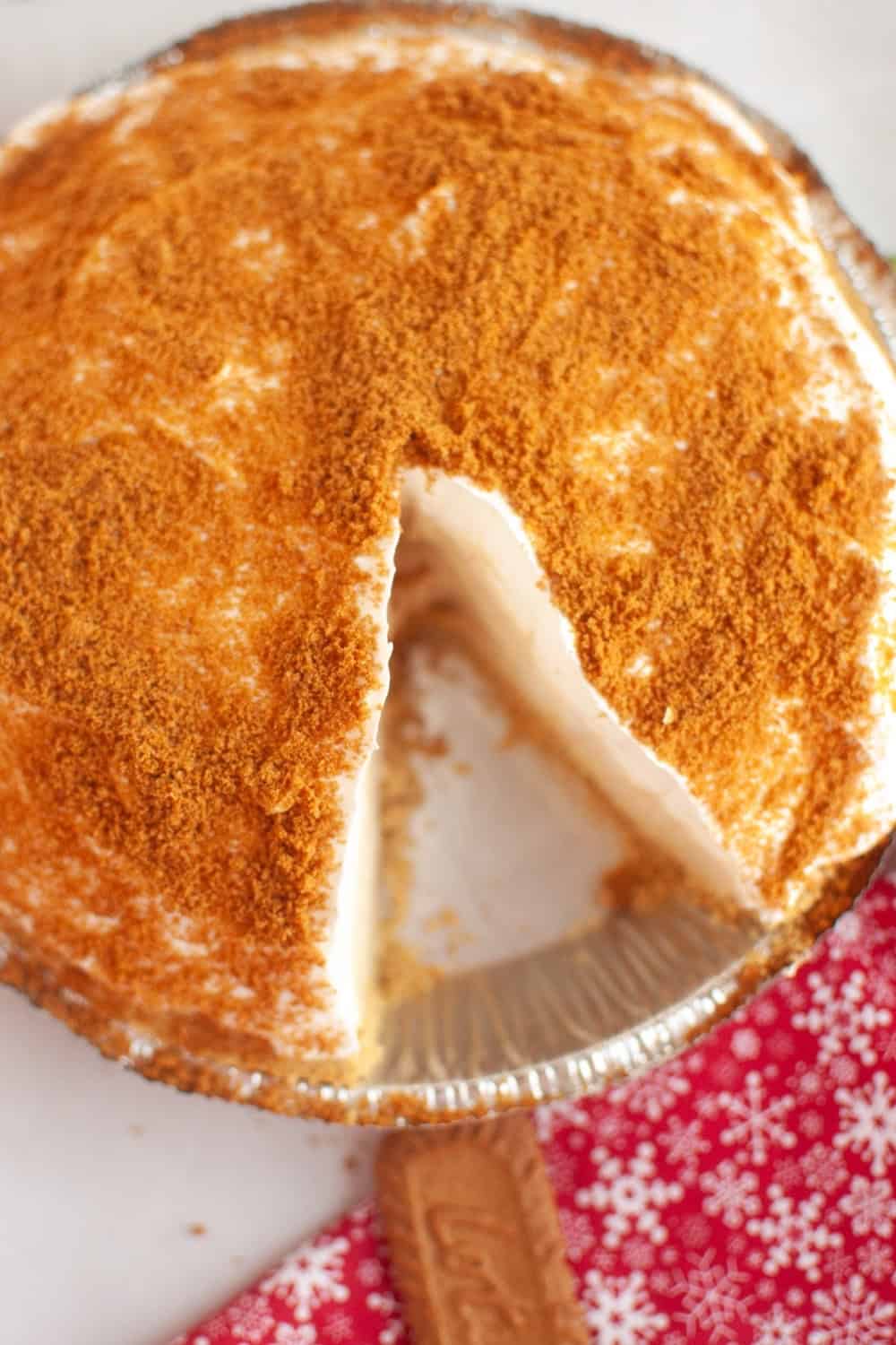 overhead view of a no bake gingerbread cheesecake pie, with a slice removed from the pan.