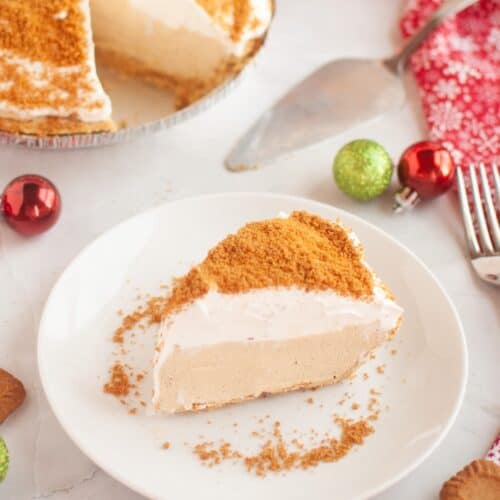 slice of no bake gingerbread cream pie served on a white plate, with the rest of the pie in the background.