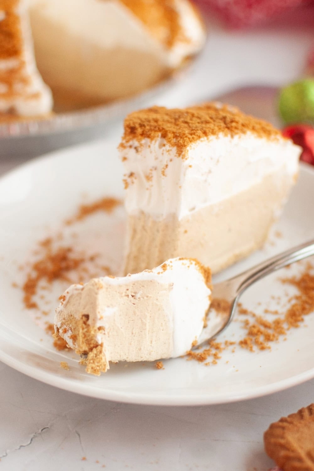 Slice of gingerbread cream pie with a bite removed, which is on a fork.