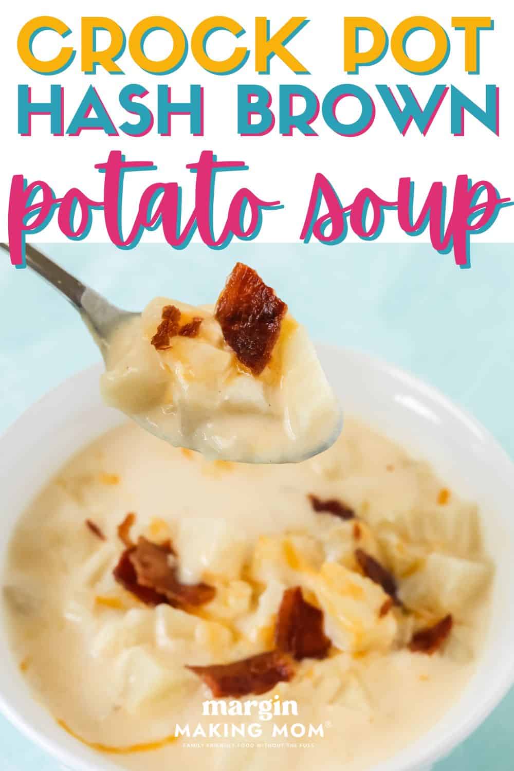 a bowl of Crock Pot hash brown potato soup, with a spoon lifting a bite out of the bowl. The soup is garnished with bacon and shredded cheese.