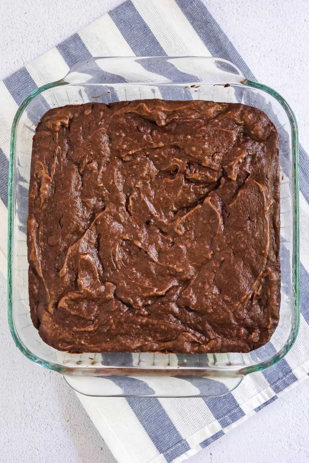 overhead view of a glass baking dish of brownies made with pudding mix.