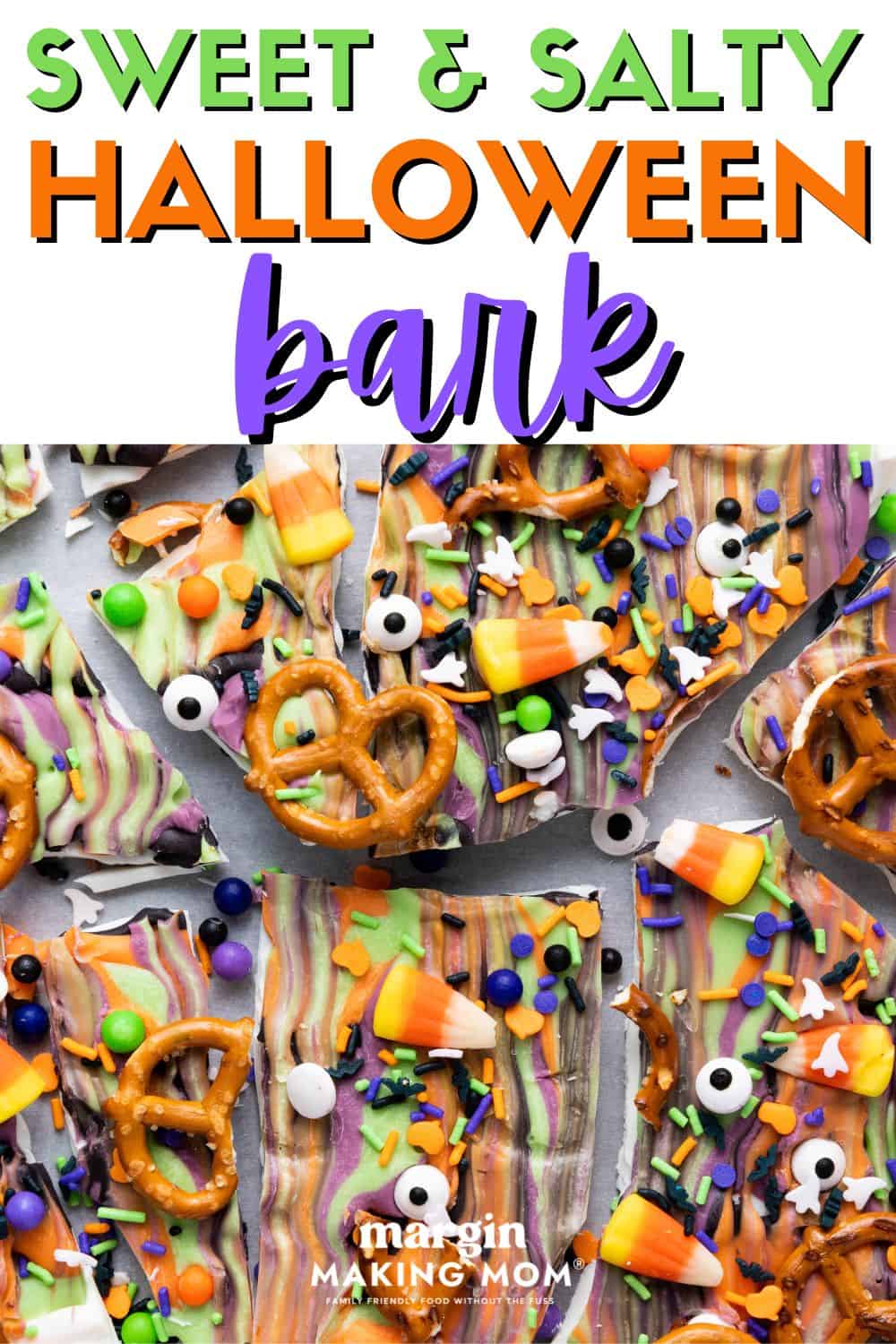 close-up view of Halloween bark pieces, which are decorated with sprinkles, candy eyeballs, pretzels, and candy corn.