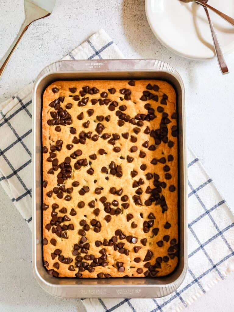 overhead view of an aluminum cake pan with vanilla pudding dump cake in it.