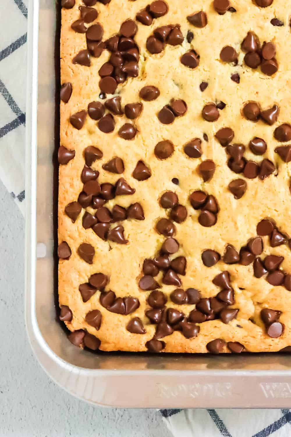 close-up view of a chocolate chip vanilla pudding dump cake in a 9x13" aluminum pan.