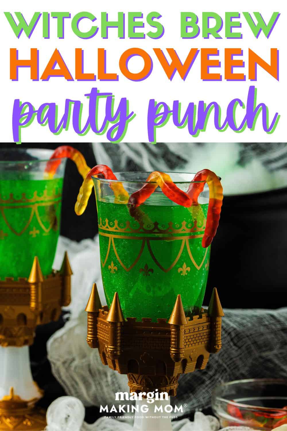 two glasses of green Witches' Brew Halloween punch, each garnished with gummy worms on the rim of the glass.