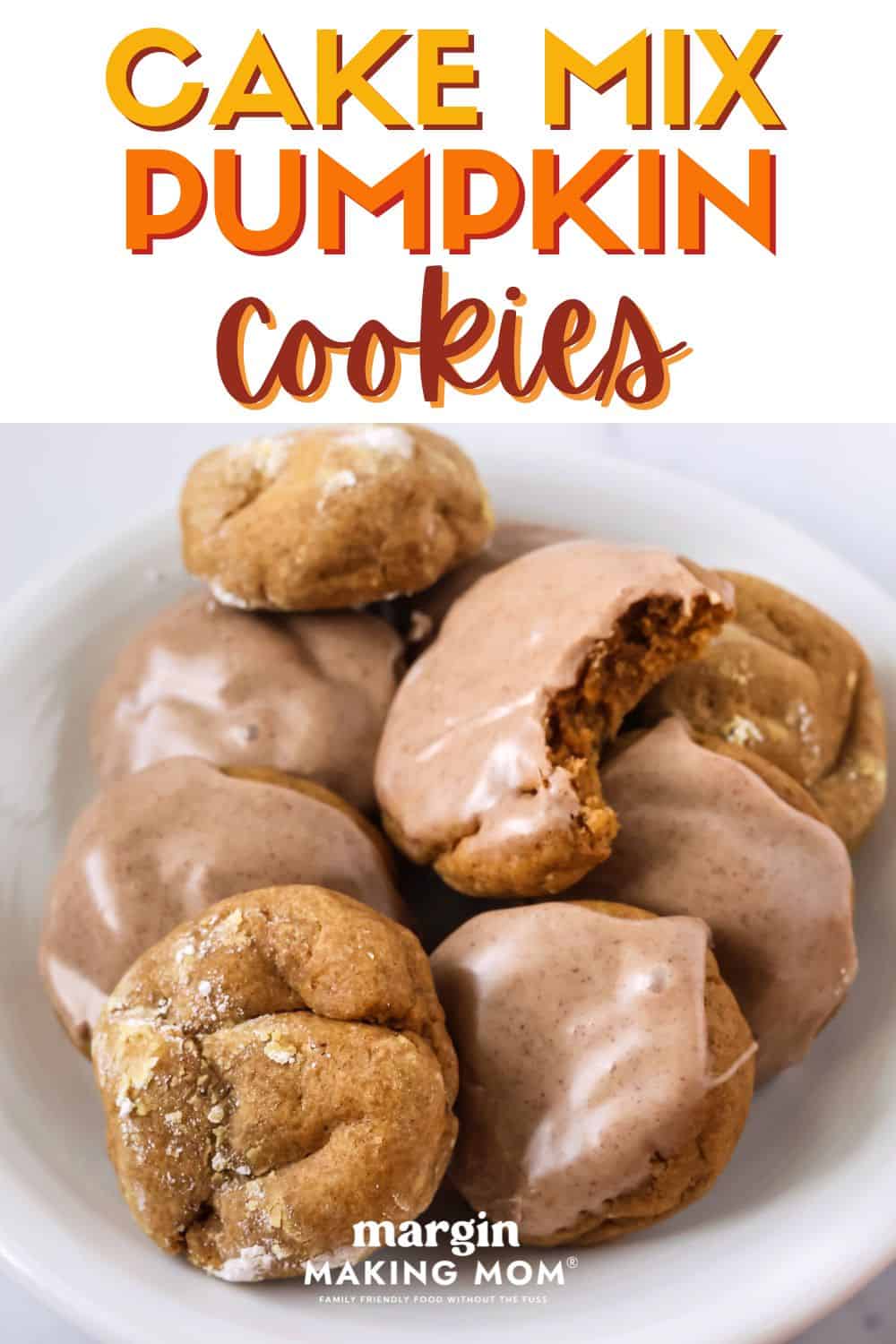 Pumpkin cookies made from cake mix are served on a white plate. Some are topped with icing, while others are rolled in powdered sugar.