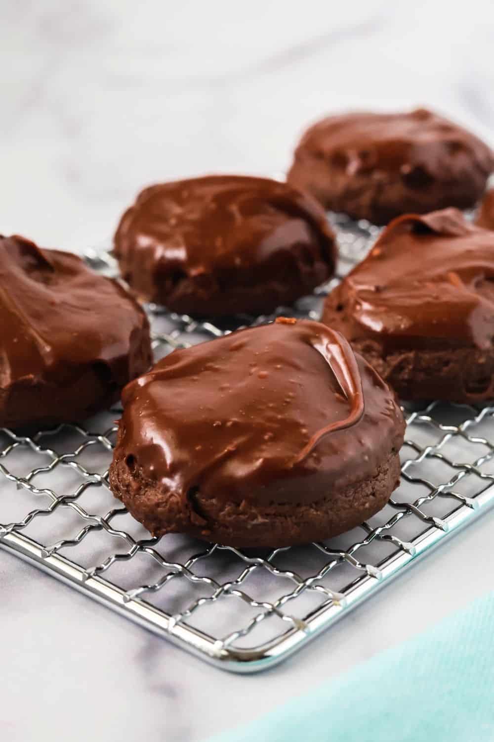 iced chocolate cream cheese cookies on a wire rack.