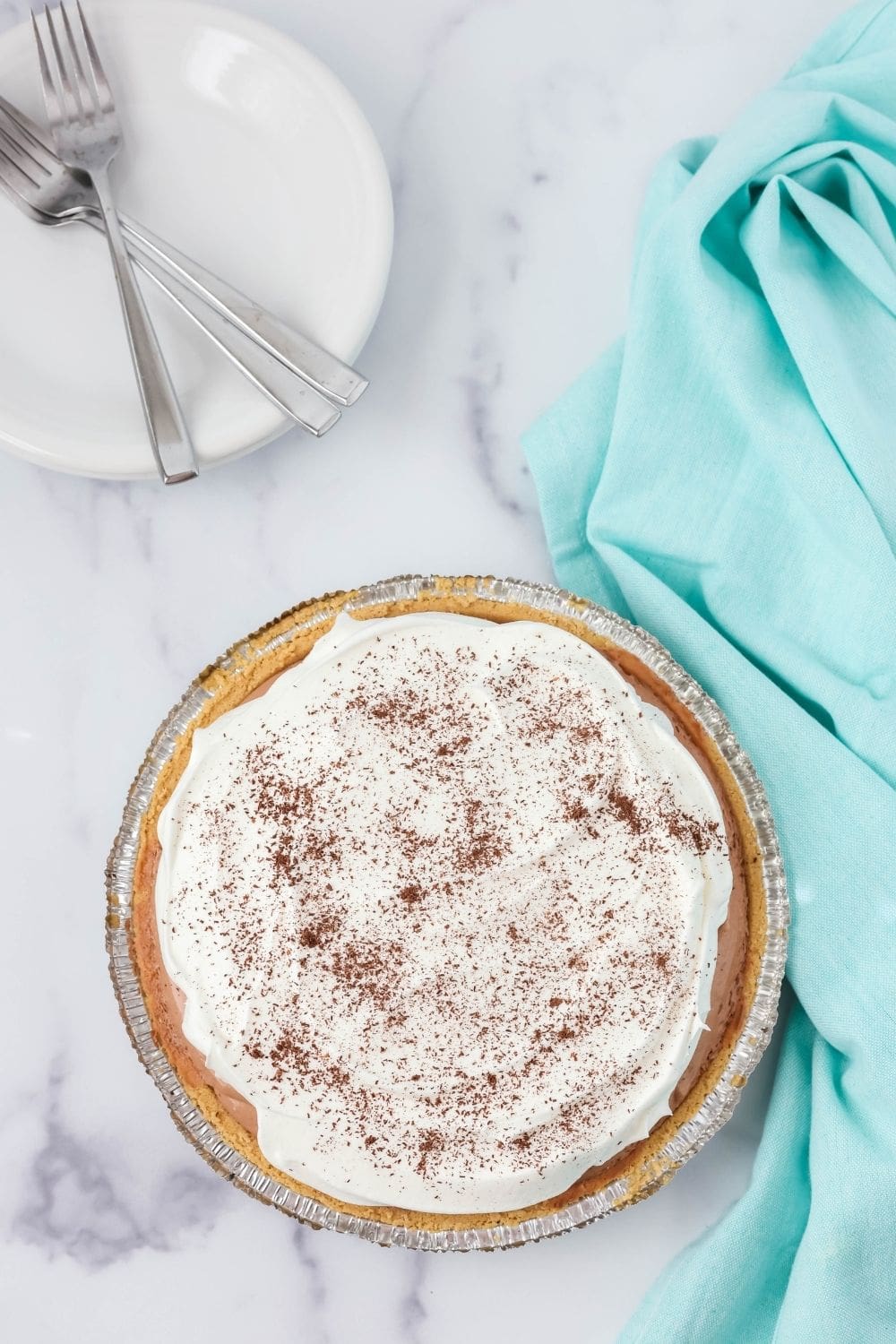 overhead view of a no-bake Dream Whip pie topped with whipped topping and chocolate shavings.