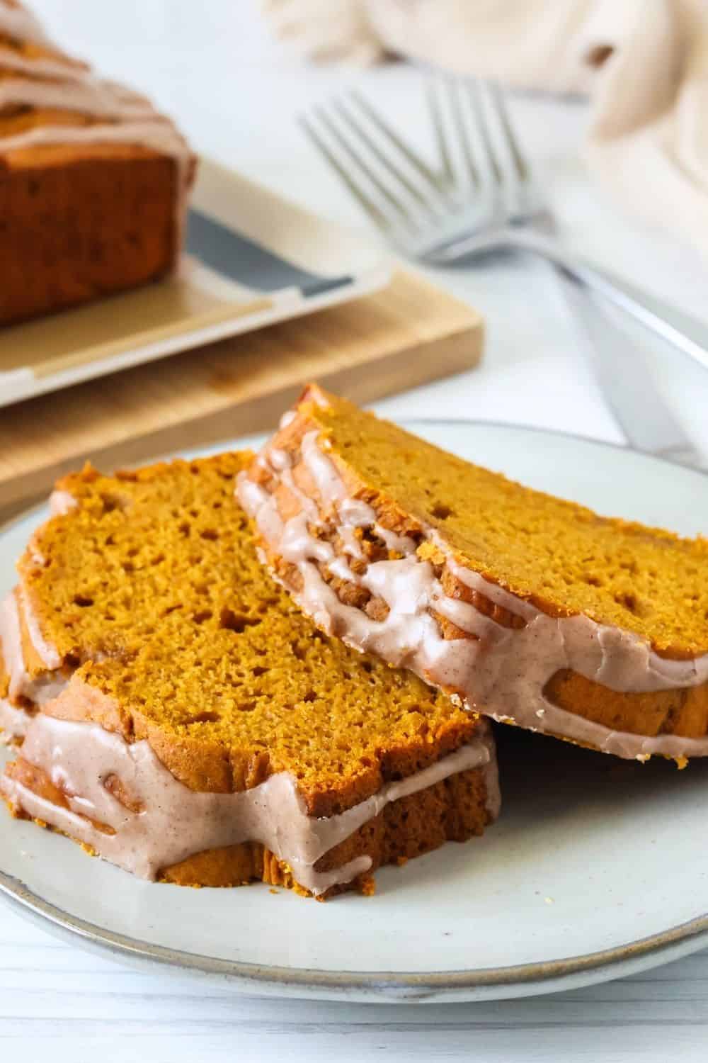 two slices of the best cake mix pumpkin bread on an ivory plate.