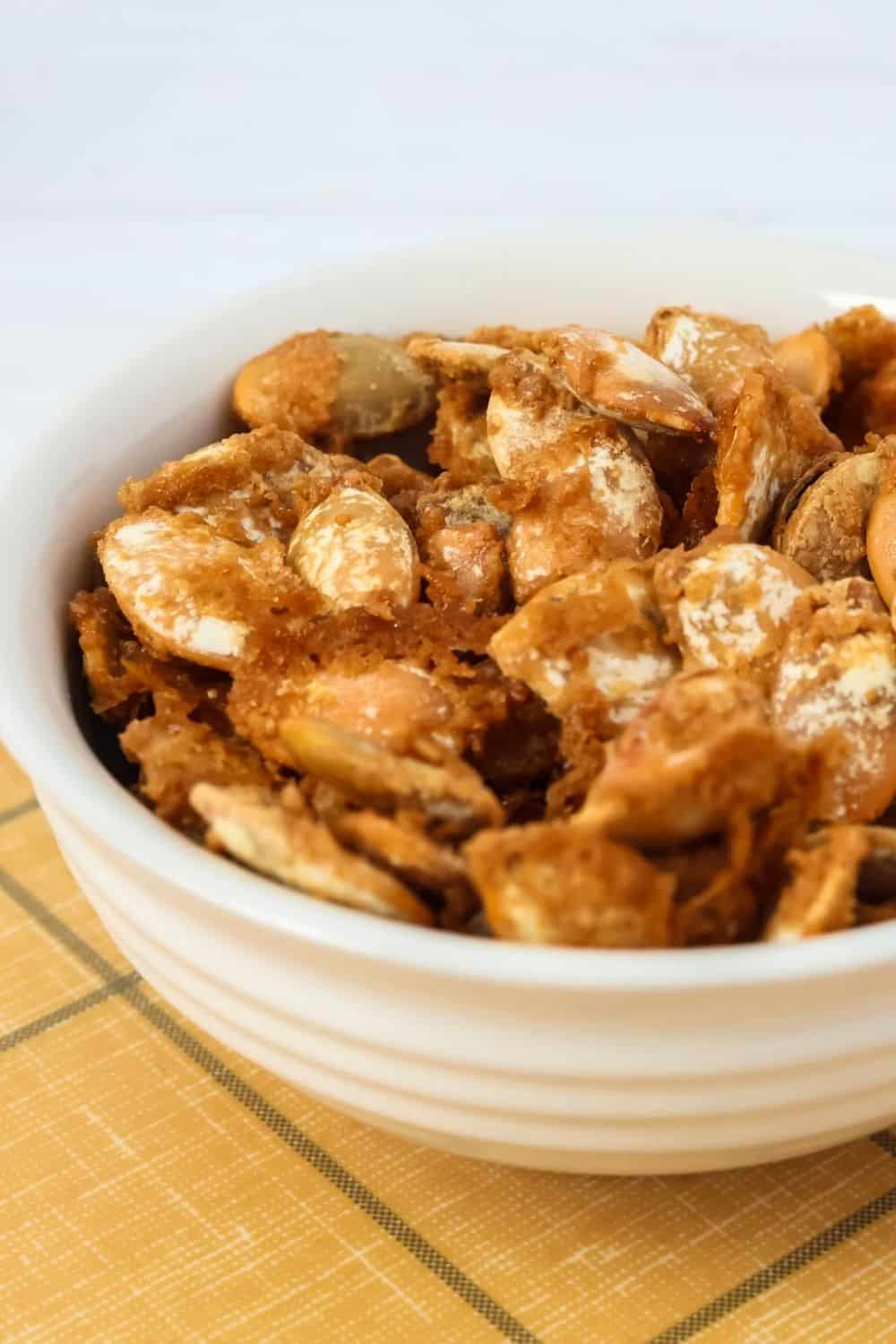 close-up view of cookie butter glazed pumpkin seeds, showing the crunchy cookie butter coating.