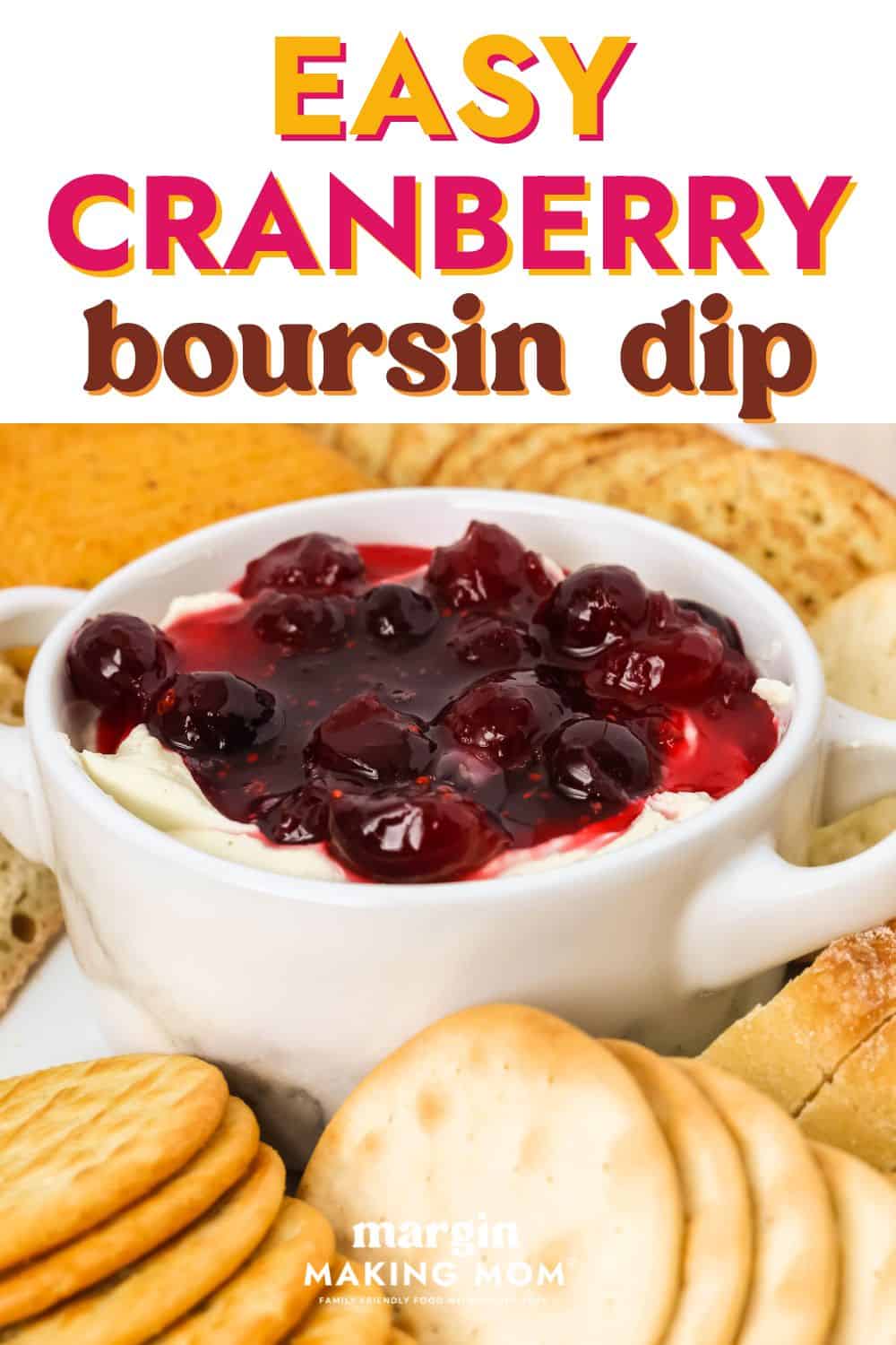 Cranberry Boursin cheese dip in a dish with crackers around it.