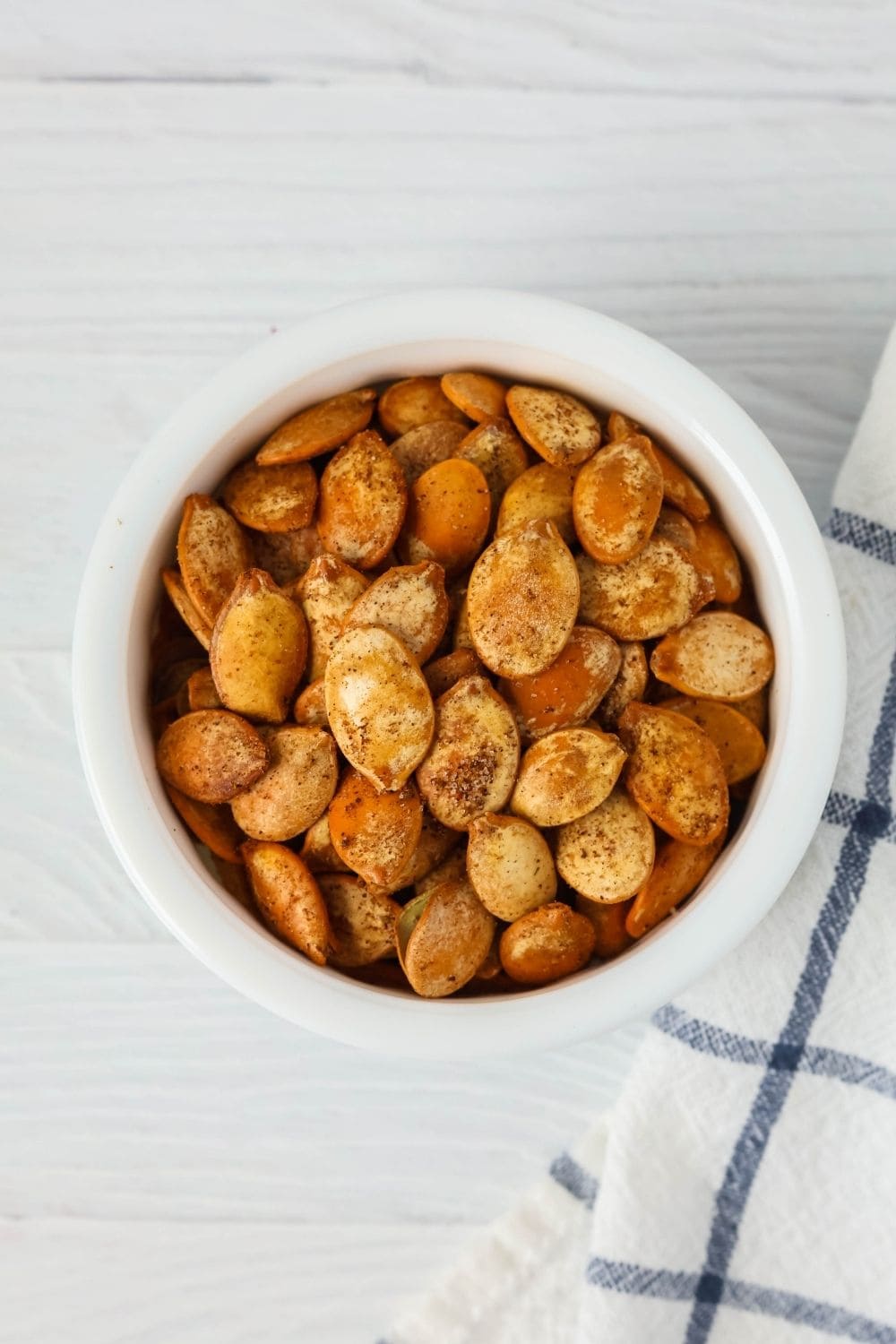 close-up overhead view of a dish of Old Bay roasted pumpkin seeds.