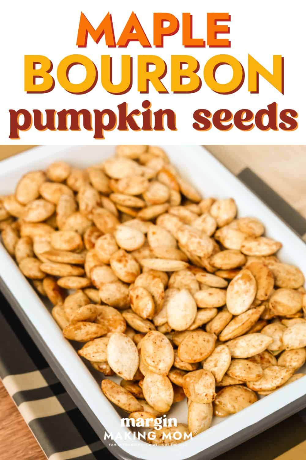close-up view of maple bourbon pumpkin seeds in a white rectangular serving dish.
