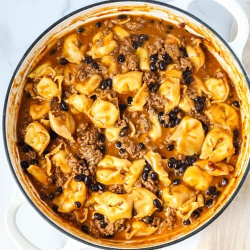 overhead view of a skillet of enchilada tortellini