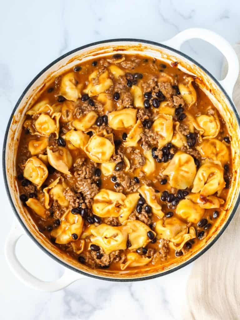 overhead view of a skillet of enchilada tortellini