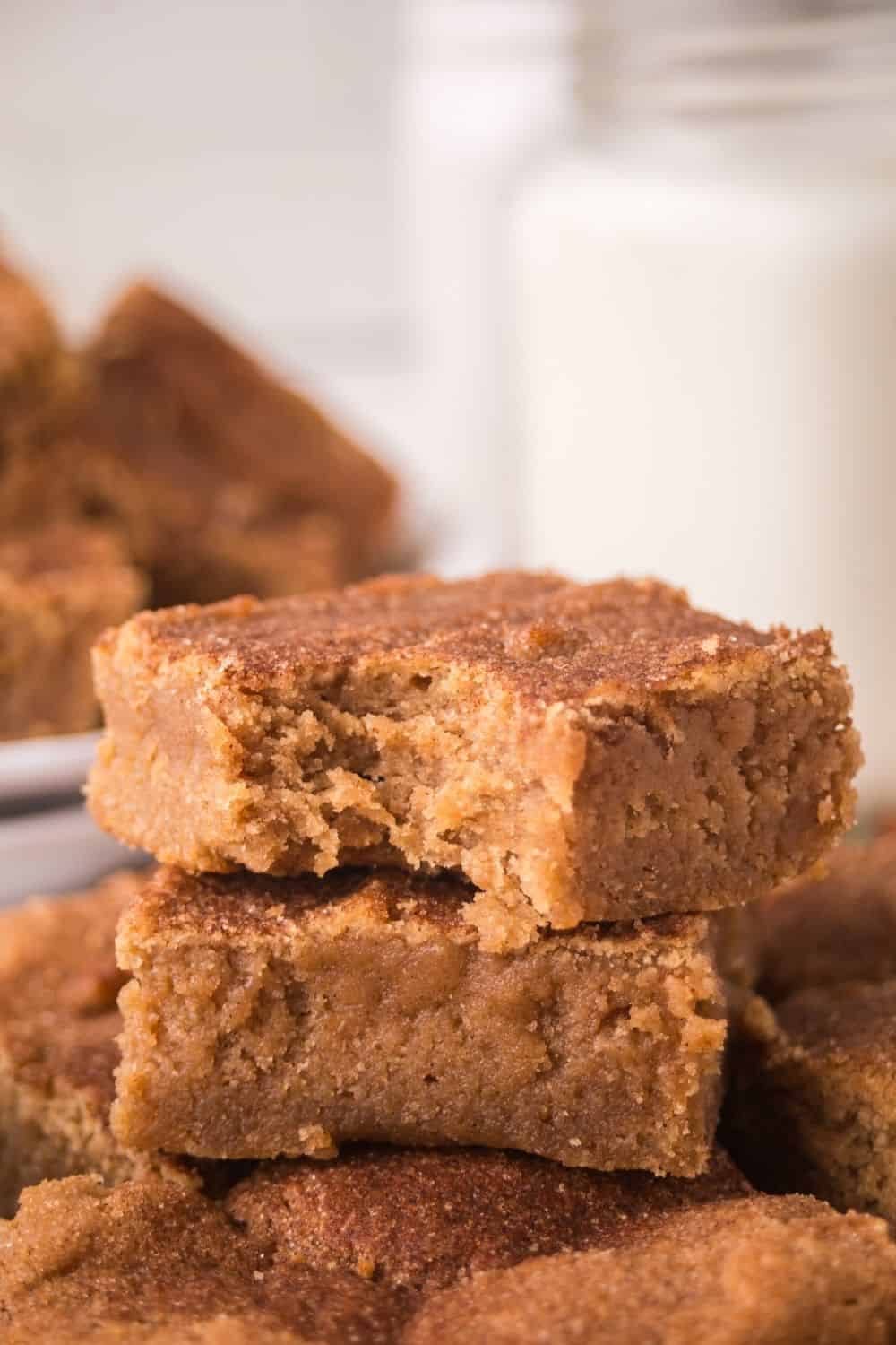 close-up view of a cinnamon sugar blondie with a bite taken out of it.
