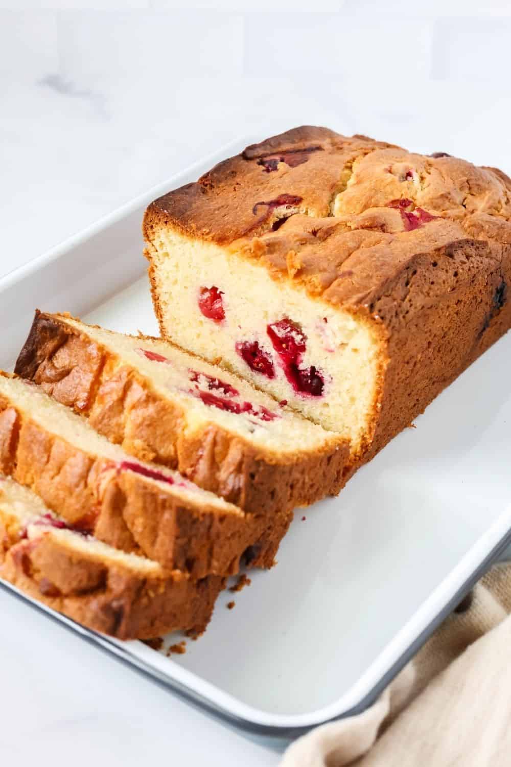 sliced cake mix cranberry loaf, showcasing the juicy cranberries dotting the cream cheese bread.