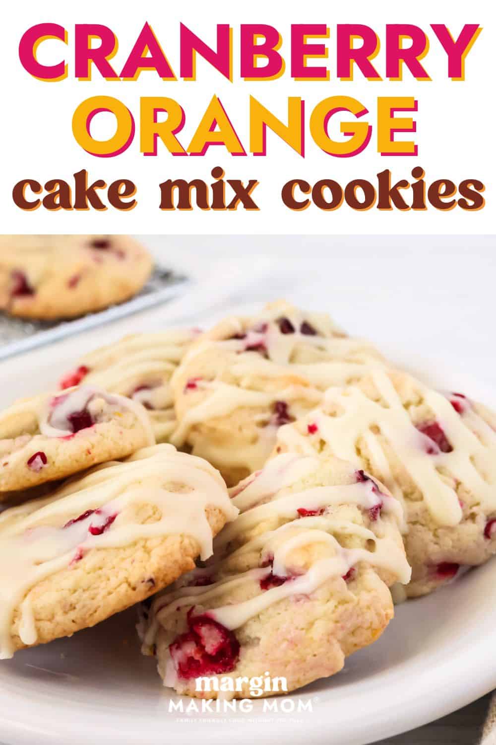 close-up view of freshly baked cranberry orange cake mix cookies on a white plate.