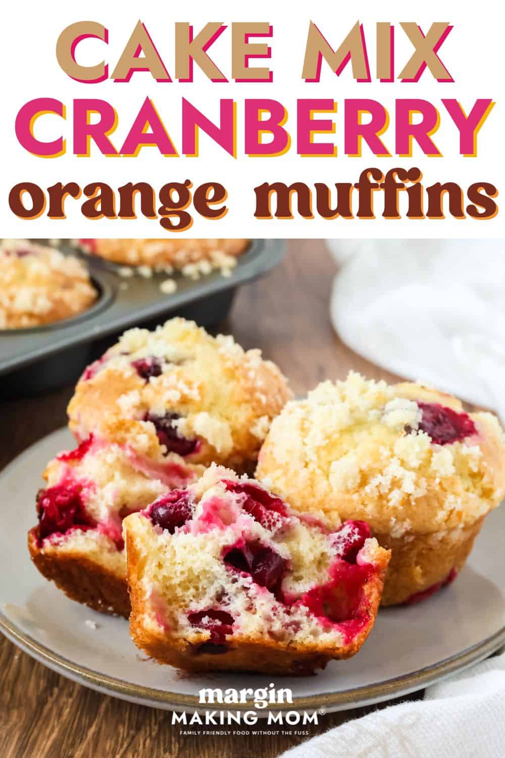 close-up view of cake mix cranberry orange muffins that are perfect for Thanksgiving and Christmas. One muffin is torn in half to show the berries inside, and all muffins are topped with streusel.