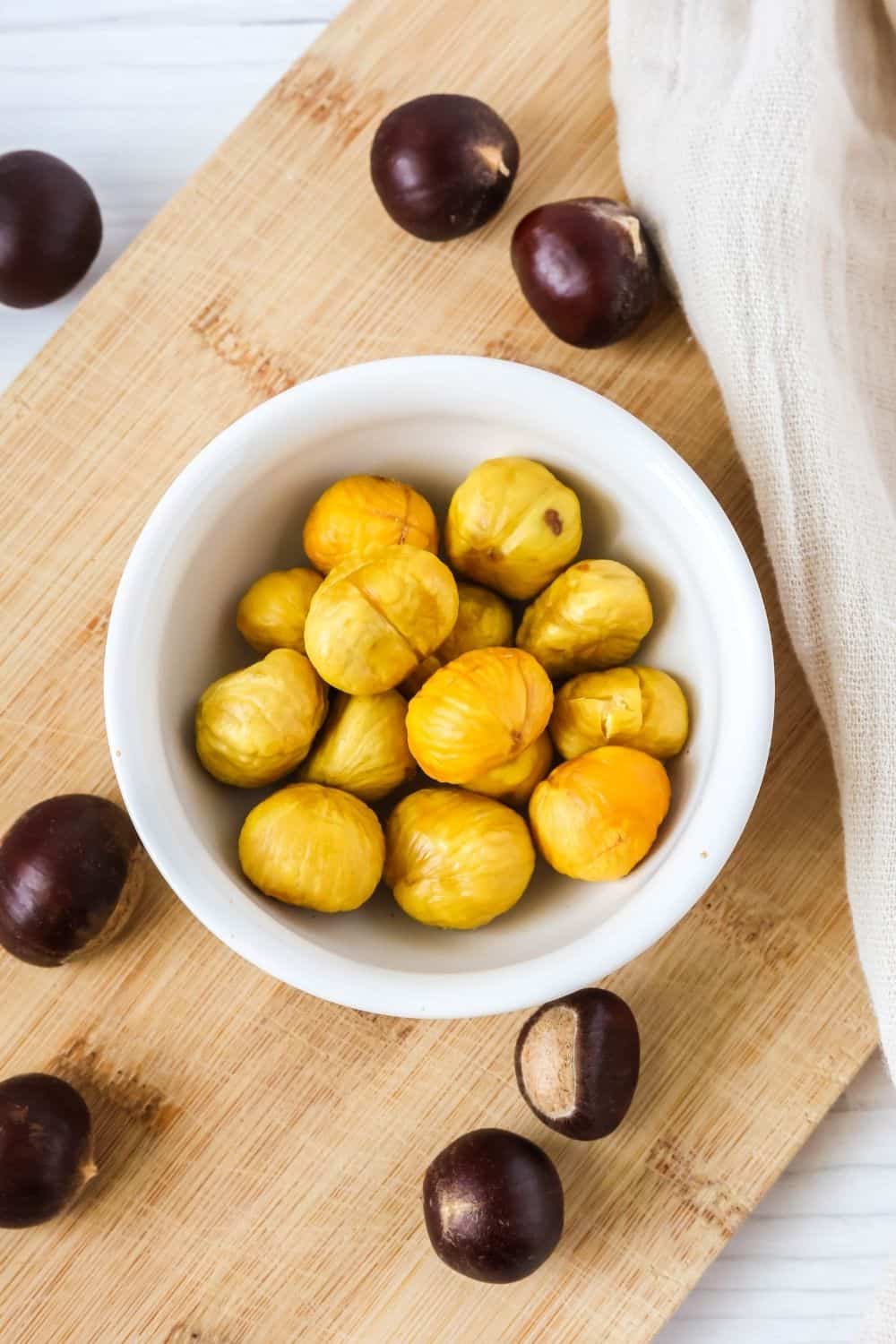overhead view of a bowl of chestnuts that were roasted in the oven, ready to be served as an appetizer or snack.