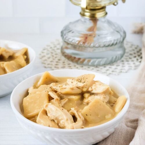 Instant Pot chicken and dumplings served in white bowls.