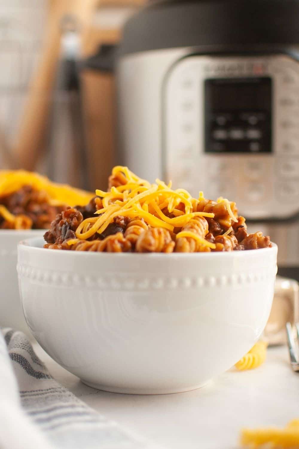side view of a white bowl filled with beef enchilada pasta cooked in the Instapot.