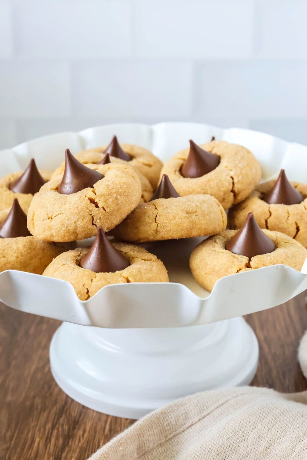 Cake mix peanut butter blossoms displayed on a white dessert stand.