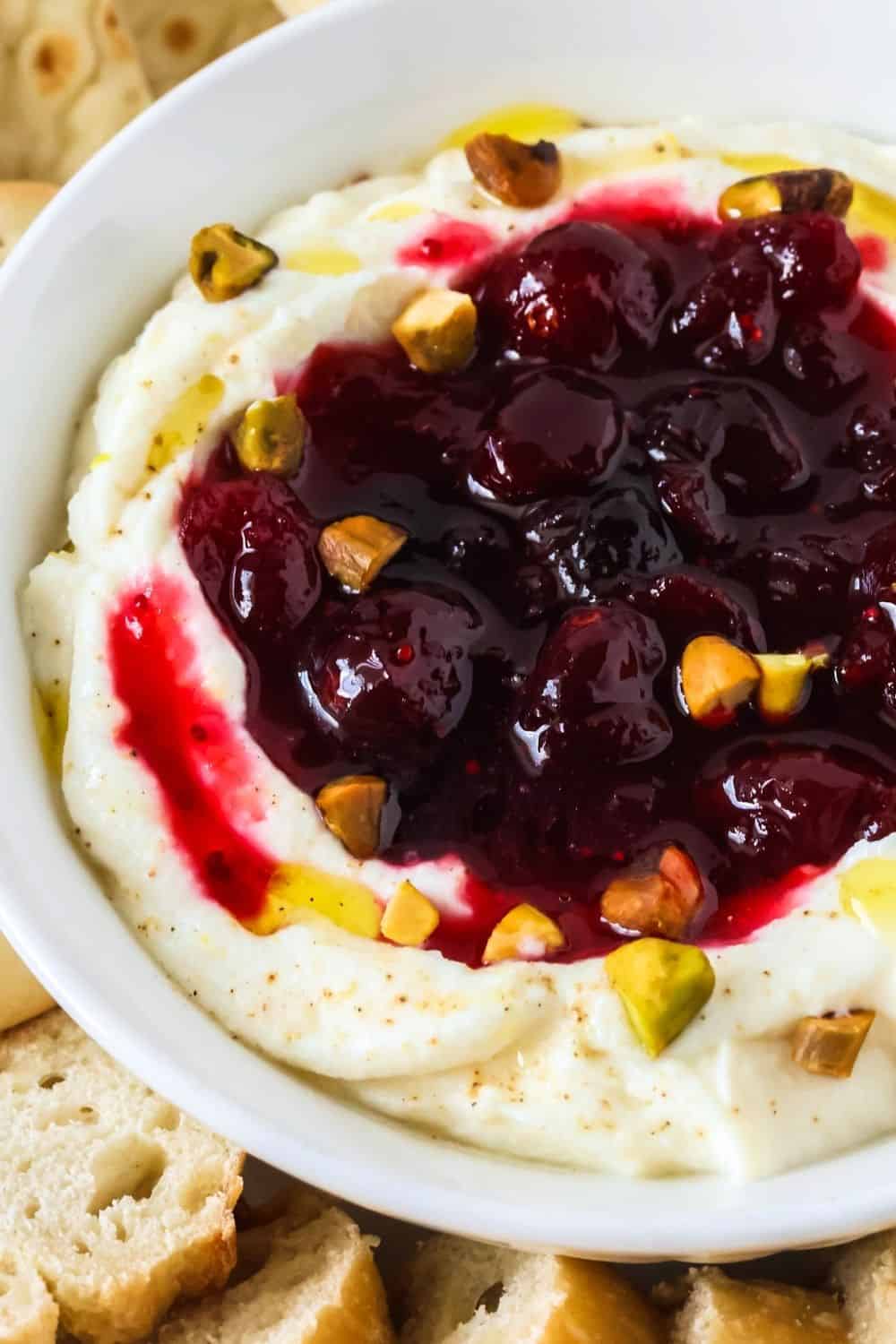 close-up view of cranberry pistachio whipped ricotta spread.