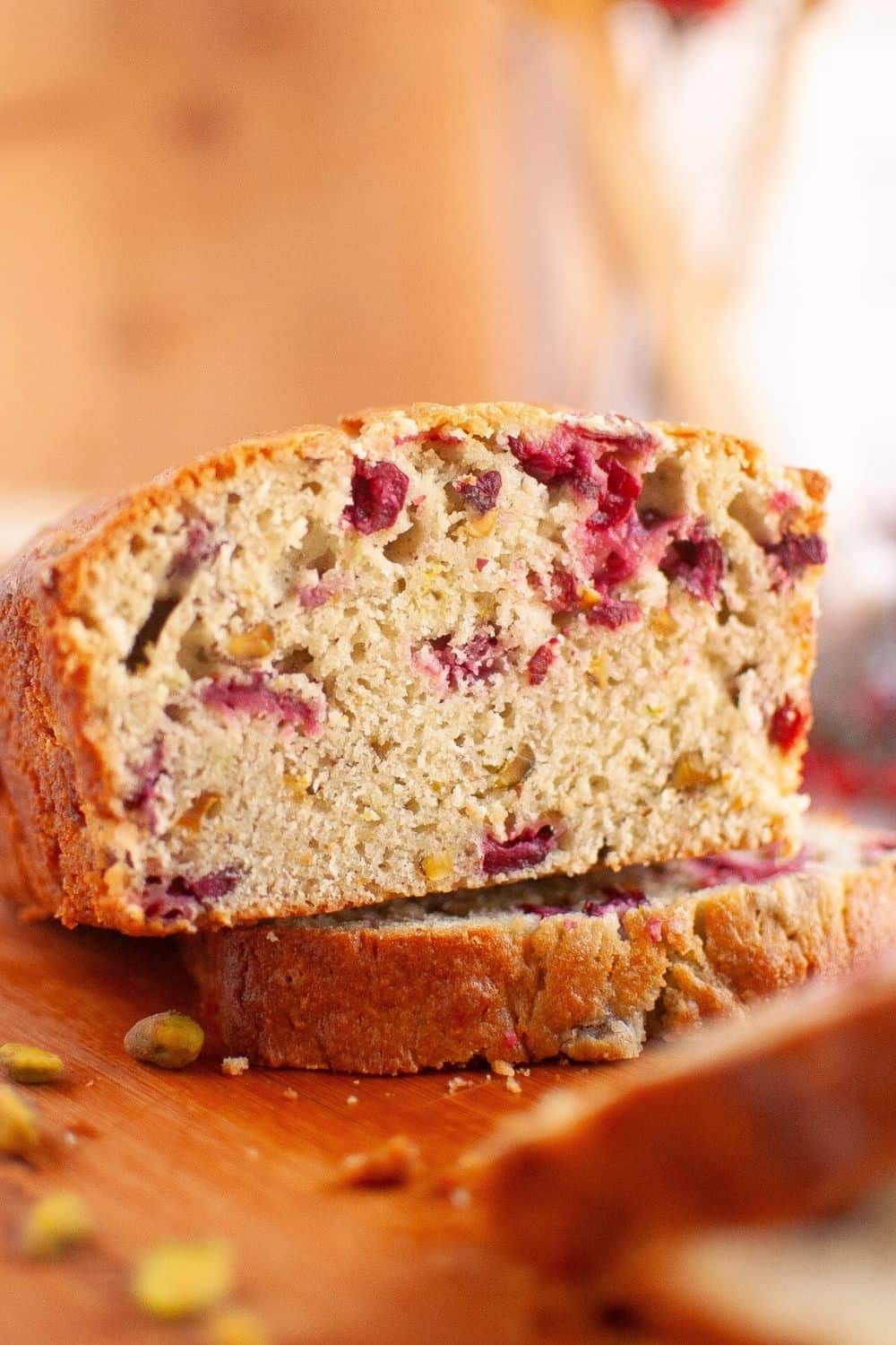 Interior of a loaf of the best pistachio cranberry bread, showcasing the nuts and cranberries inside.