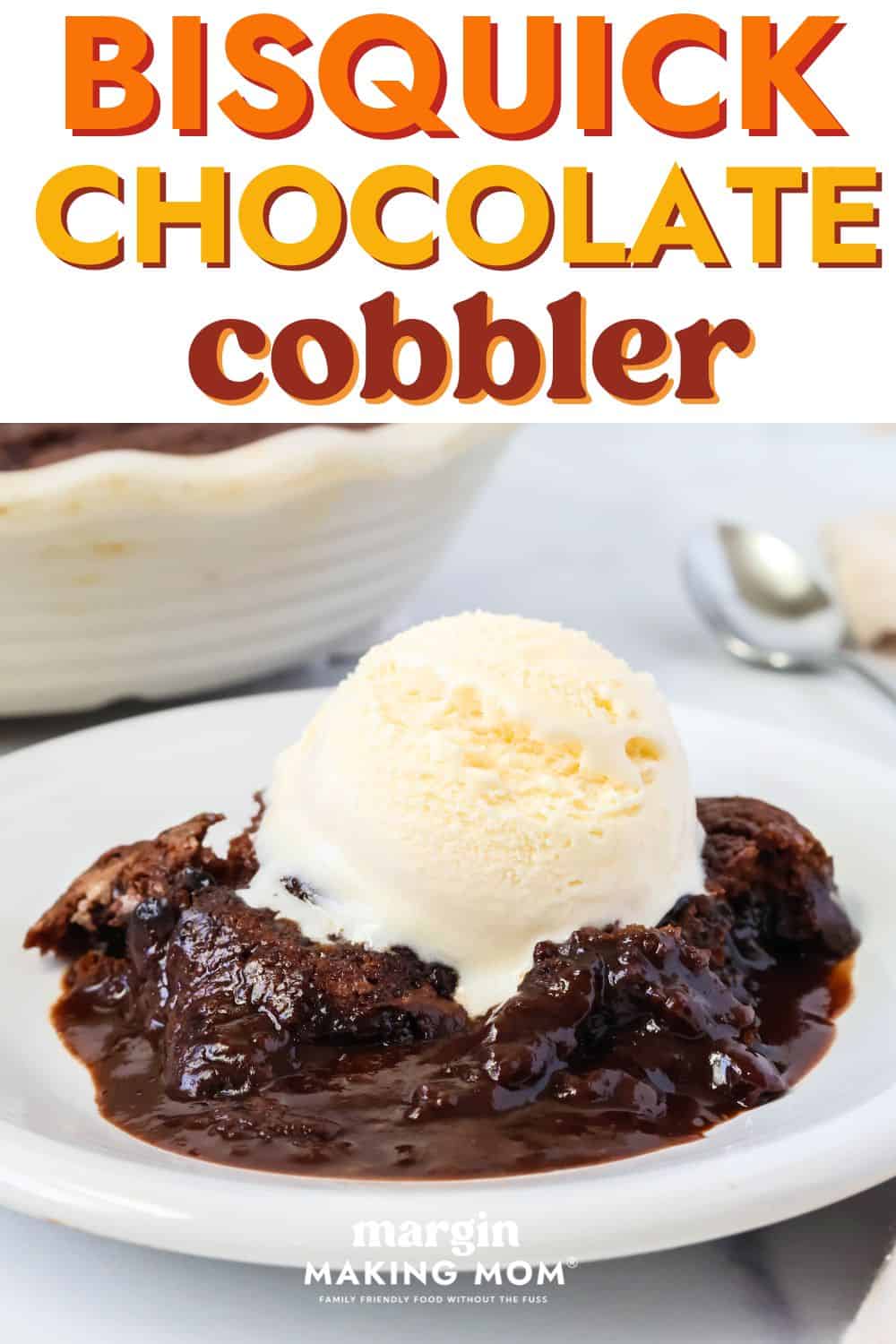 side view of a helping of Bisquick chocolate cobbler on a white plate, garnished with a scoop of vanilla ice cream.