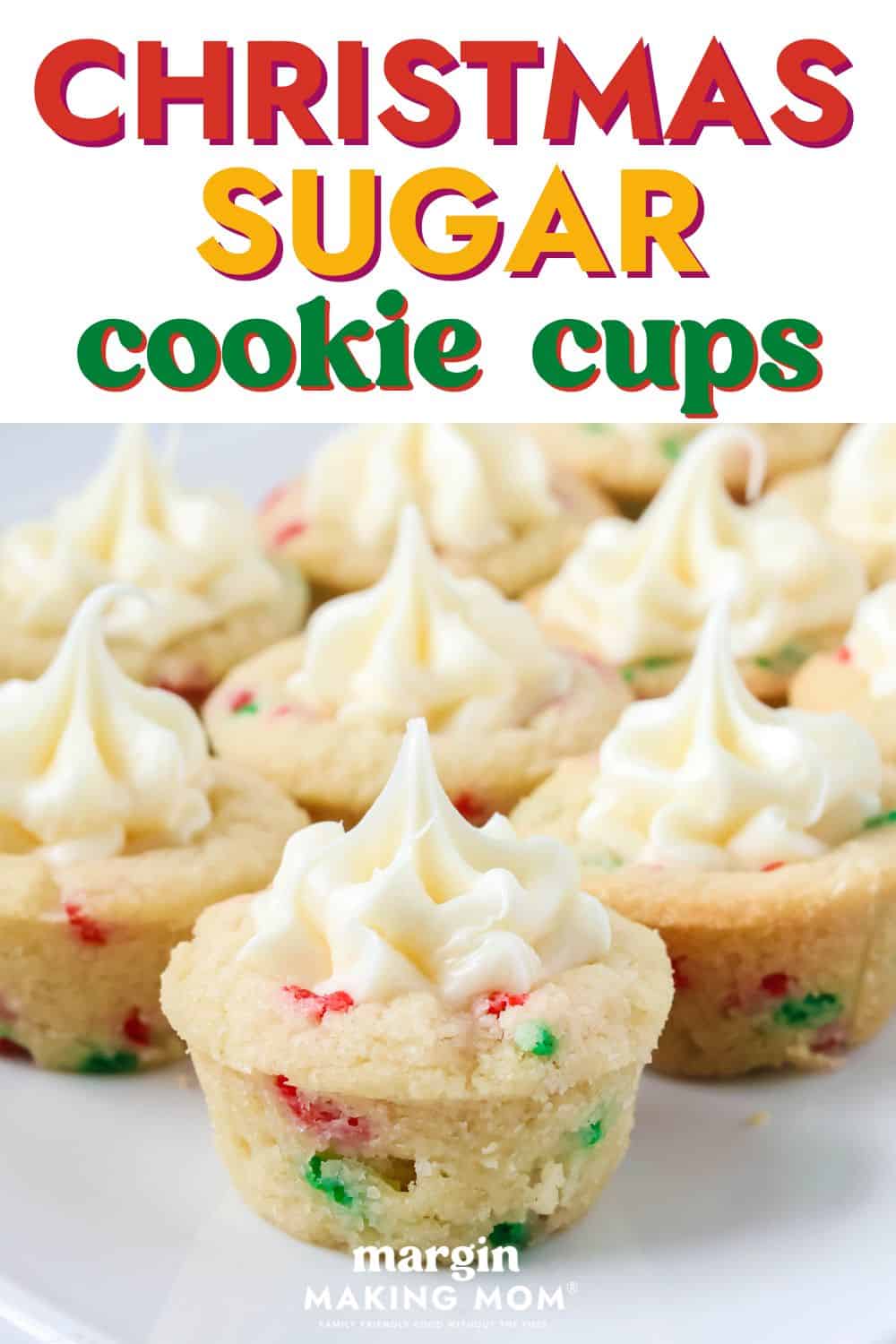 close-up view of easy Christmas sugar cookie cups, filled with piped vanilla frosting, served on a white plate.
